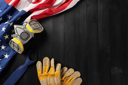 Happy Labor day. Several engineer constructor work tools and American flag with copy space on black...