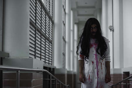 Female zombie in blood devil is scary she haunted at the abandoned building, Horror evil woman ghost creepy in room at house, Happy Halloween festival day conceptの写真素材