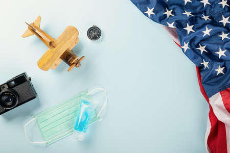 World Tourism Day during pandemic, model plane with face mask and American flag, STOP and safe...