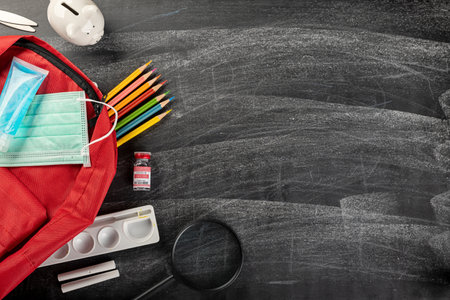 Back to school or college concept. Top view of school supplies stationery, backpack and surgical...