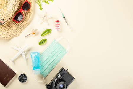 World Tourism Day during coronavirus outbreak, Top view model plane and medicine face mask, holiday accessory beach trip travel vacation, studio shot isolated pastel background with copy spaceの写真素材