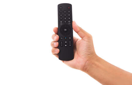 Hand holding television and audio remote control panel, studio shot isolated on over white...