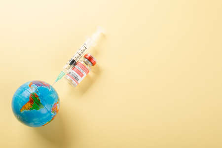 Vaccine vials bottles, syringes for vaccination against coronavirus and globe, medicine illness,...