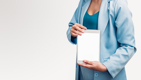 Young business woman holding and show screen digital technology tablet computer on her hand isolated white backgroundの写真素材
