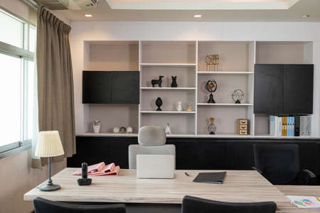 Comfortable office chair near wooden table with laptop computer, Interior of an office desk...