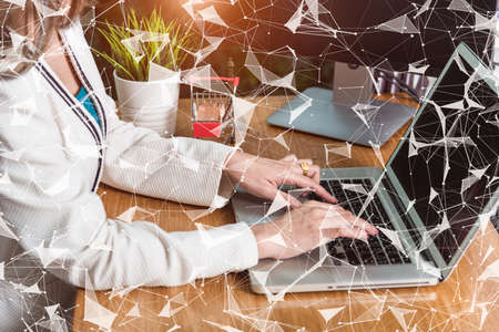 Businesswoman working at home with laptop on desk with digital global network