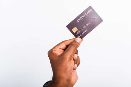 Closeup hand black man holding bank mockup money credit card on hand for payment transfer, studio shot isolated on white backgroundの写真素材