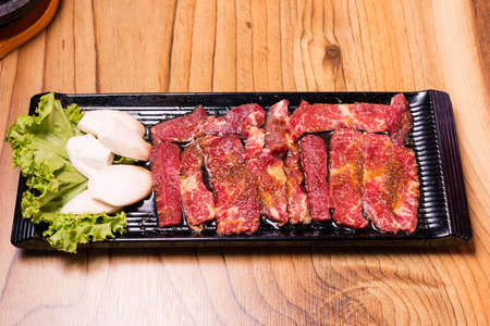 Raw pork on plate, Korean traditional style fresh pork beef belly BBQ, Japanese meat hot pot or Shabu in the restaurant, barbecue foodの写真素材