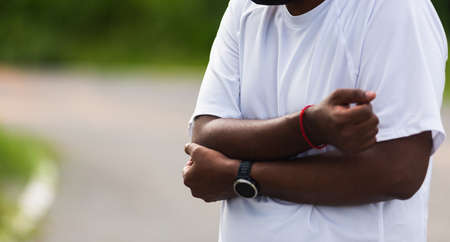 Close up Asian young sport runner black man wear watch he having elbow pain and use hands joint hold...