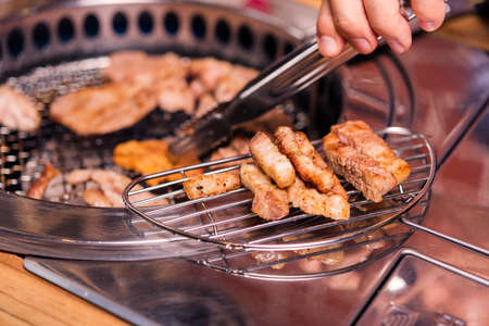 Korean beef barbecue on hot coals. Grilling meat pork Korean BBQ traditional style on stove serve in restaurant, Japanese foodの写真素材