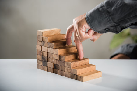 Business two finger symbol walking up on wood blocks shape staircase to climb up career ladder step...