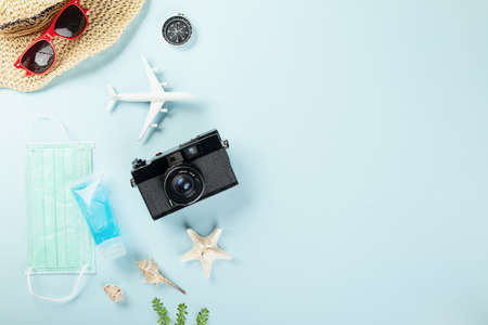 World Tourism Day during  pandemic, Travel accessories objects flat lay, studio shot isolated blue...