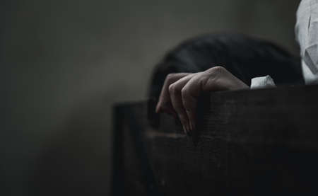Horror ghost woman. Asian ghost horror creepy scary have hair covering face and eye lying in the old treasure chest, female makeup terror zombie face, murder, Closeup hand, Happy Halloween day conceptの写真素材