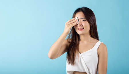 Facial Beauty Treatment Hygiene skin. Asian beautiful young woman removing cosmetic make up using...
