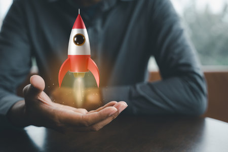 Business startup. Businessman holding rocket 3D icon on hand, rocket takes off launching and soar flying out, marketing on modern virtual interface, business digital innovation accelerate idea conceptの写真素材