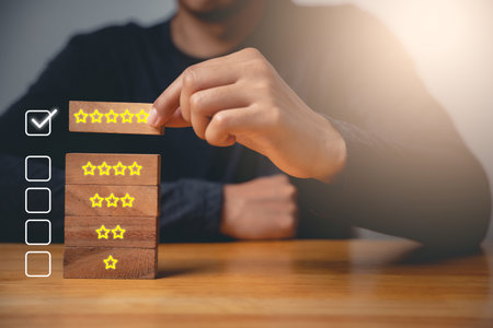 5 stars rating feedback. Customer review experience for good quality give satisfaction, Business hand people choose hold wood block five star icon rating to best excellent service, checkboxの写真素材