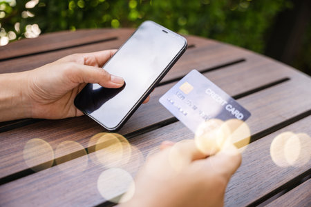 Close up hand of woman using credit card and smartphone during slide screen for finding product purchase buying payments online shopping, making secure internet payment browsing banking serviceの写真素材