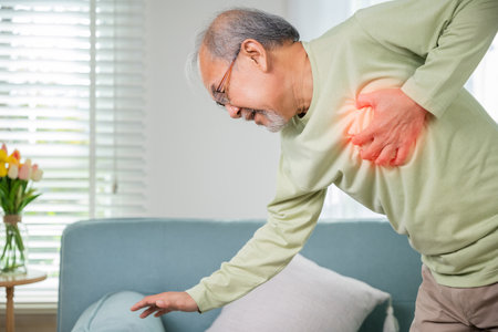 Asian older man have congenital disease suffering from heartache alone at home, Senior man bad pain...