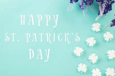 Happy St Patricks Day decoration background. above top view of paper clover leaves festive decor,...