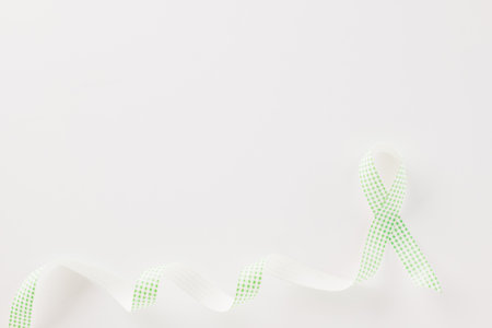 Green awareness ribbon of Gallbladder and Bile Duct Cancer month isolated on white background with copy space, concept of medical and health care supportの写真素材