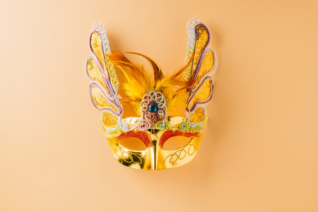 Happy Purim carnival decoration. Golden venetian ball mask, carnival mask isolated on pastel background, Purim or Mardi Gras in Hebrew, Masquerade party eventの写真素材