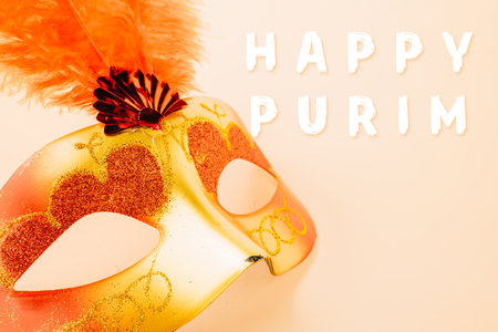 Happy Purim carnival decoration. Top view venetian ball mask with red feather on pastel background, Jewish Purim or Mardi Gras in Hebrew, holiday background banner design, Masquerade partyの写真素材