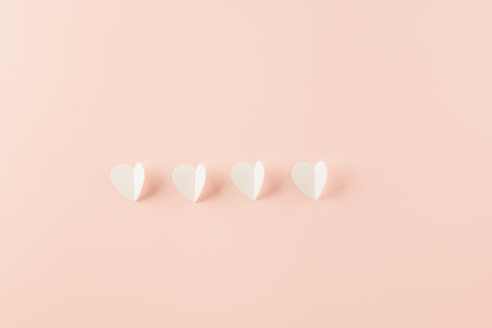 Happy Valentines Day background. Top view flat lay of paper elements cutting white hearts shape flying on pink background with copy space, Happy Mothers Day, Banner template design of holidayの写真素材