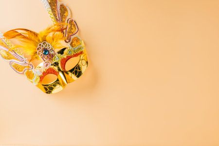 Happy Purim carnival decoration. Jewish Purim and Mardi Gras in Hebrew, celebration holiday background banner design, Golden venetian ball mask, carnival mask isolated on pastel backgroundの写真素材