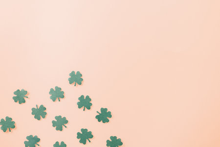 Happy St. Patricks Day decoration background. Flat lay of cutting paper clover leaves festive decor,...