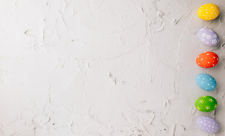 Happy Easter Day Concept. Top view holiday banner background web design white colorful easter eggs painted on cement background with empty copy space, celebration greeting card, overhead, templateの写真素材