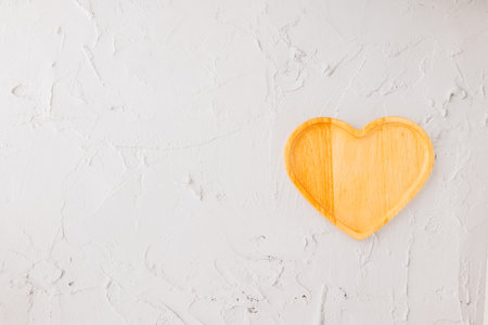 Empty heart shape wooden tray isolated on white cement background, top view, flat lay, dish plate or bowl wood for food, Collection, happy valentine dayの写真素材