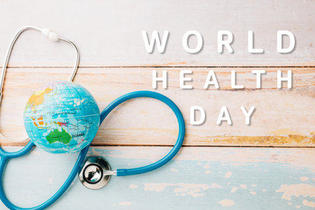 World Health Day. Blue doctor stethoscope and world globe isolated on wooden background with copy space for text, Save world day, Green Earth Environment, Healthcare and medical conceptの写真素材