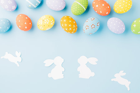 Easter eggs bunny and rabbit white paper cut isolated on blue background copy space, Funny decoration, Creative composition banner web design holiday background, Happy Easter Day, flat lay top viewの写真素材