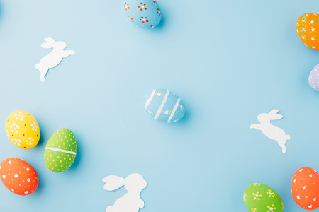 Easter eggs bunny and rabbit white paper cut isolated on blue background copy space, Funny decoration, Creative composition banner web design holiday background, Happy Easter Day, flat lay top viewの写真素材
