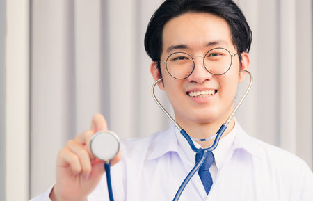 Doctor Day. Nurse man smiling in uniform with doctor stethoscope holding and show stethoscope, Healthcare medicine insurance conceptの写真素材