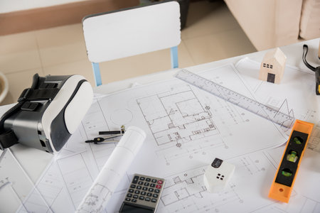 Architectural blueprint paper project plans on desk table, tool for engineer contractor building...