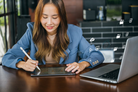 Lifestyle creative hobby woman digital artist draws a digital picture on digital tablet at cafe shop, Asian female artist illustrator painting drawing on touch pad digital tablet with stylus penの写真素材