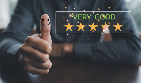 The power of customer satisfaction. A hand with a thumbs up and five-star icon, signifying positive feedback and excellent service. Perfect for digital marketing, reviews, and surveysの写真素材