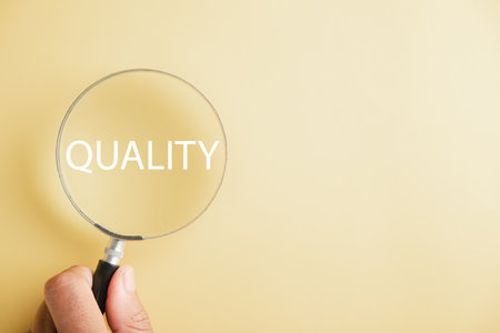 Magnifying glass against enhances the word Quality emphasizing the concept of control and compliance. It represents the rules, policies, and regulations that ensure the companys Terms and Conditions.の写真素材