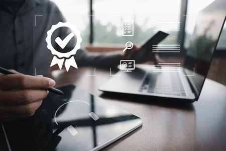Businessman holding a tablet computer showcasing ISO certification and quality assurance. International standards compliance and assurance of top service is guaranteed. Digital technology is the key.の写真素材