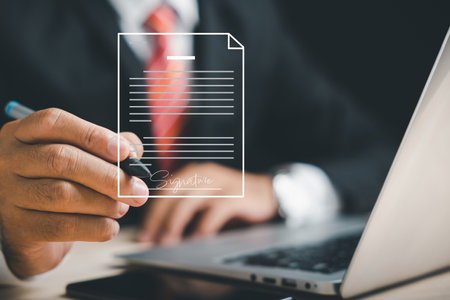 Electronic signature concept and technology for paperless offices. Businessman signs electronic documents on virtual screen using pen. Digital document management is showcased.の写真素材