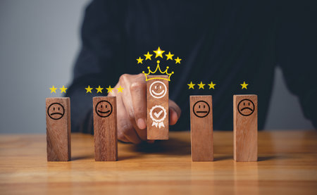 Satisfied customer handpicking wooden block with 5 star icon to give excellent feedback and service rating concept for successful businessの写真素材