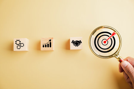 Target icon magnified through magnifying glass, highlighting connection to start-ups, creative ideas, and innovation. the concept of leadership, customer targeting, and motivation for success.の写真素材