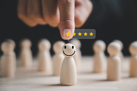 Selecting a happy face wooden figure for success. Customer service rating, feedback, and satisfaction survey. HR management choosing a positive attitude in team leadership. Human Resource Managementの写真素材