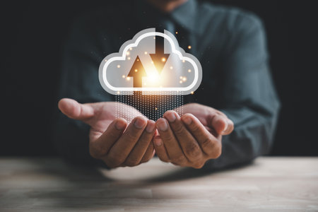 The cloud computing icon rests in the hand of a visionary businessman, the businessman exemplifies...