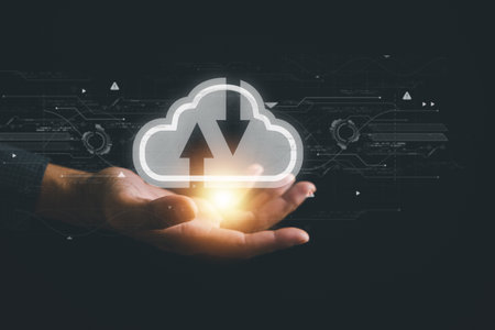 With a firm grasp on the cloud computing icon, the businessman exemplifies the benefits of cloud technology. Effortless data transfer and robust online storage for business network on the internet.の写真素材
