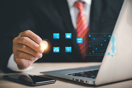 Using a laptop and digital pen, a businessman safeguards business performance in the digital world. Explore the concepts of social media marketing and big data.の写真素材