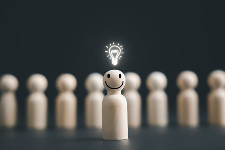 A wooden figure with a glowing light bulb symbolizes creativity and inspiration. Leadership fosters teamwork and the exchange of ideas, leading to innovative thinking and problem-solving.の写真素材