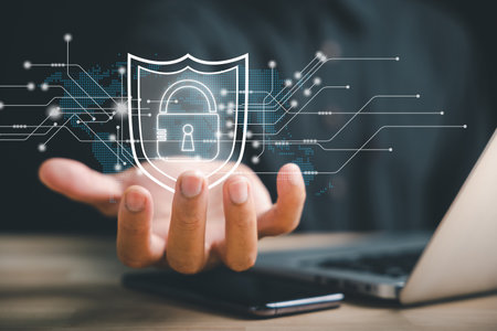 Protect your data with network security and shield icon. Businessman holds shield protect symbol, emphasizing the concept of cybersecurity and protection against dangers in the digital world.の写真素材