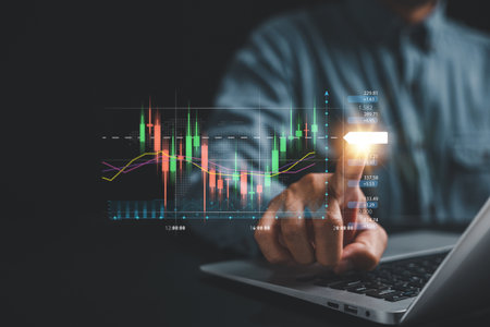 Investment strategy and progress concept. Traders hand points at a virtual hologram stock on a...